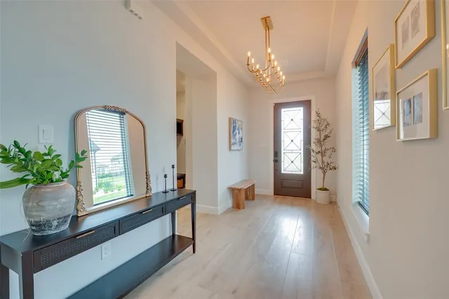 a view of a room with wooden floor and windows