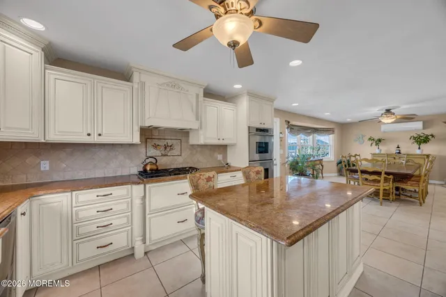 a bedroom with a large bed and a chandelier fan