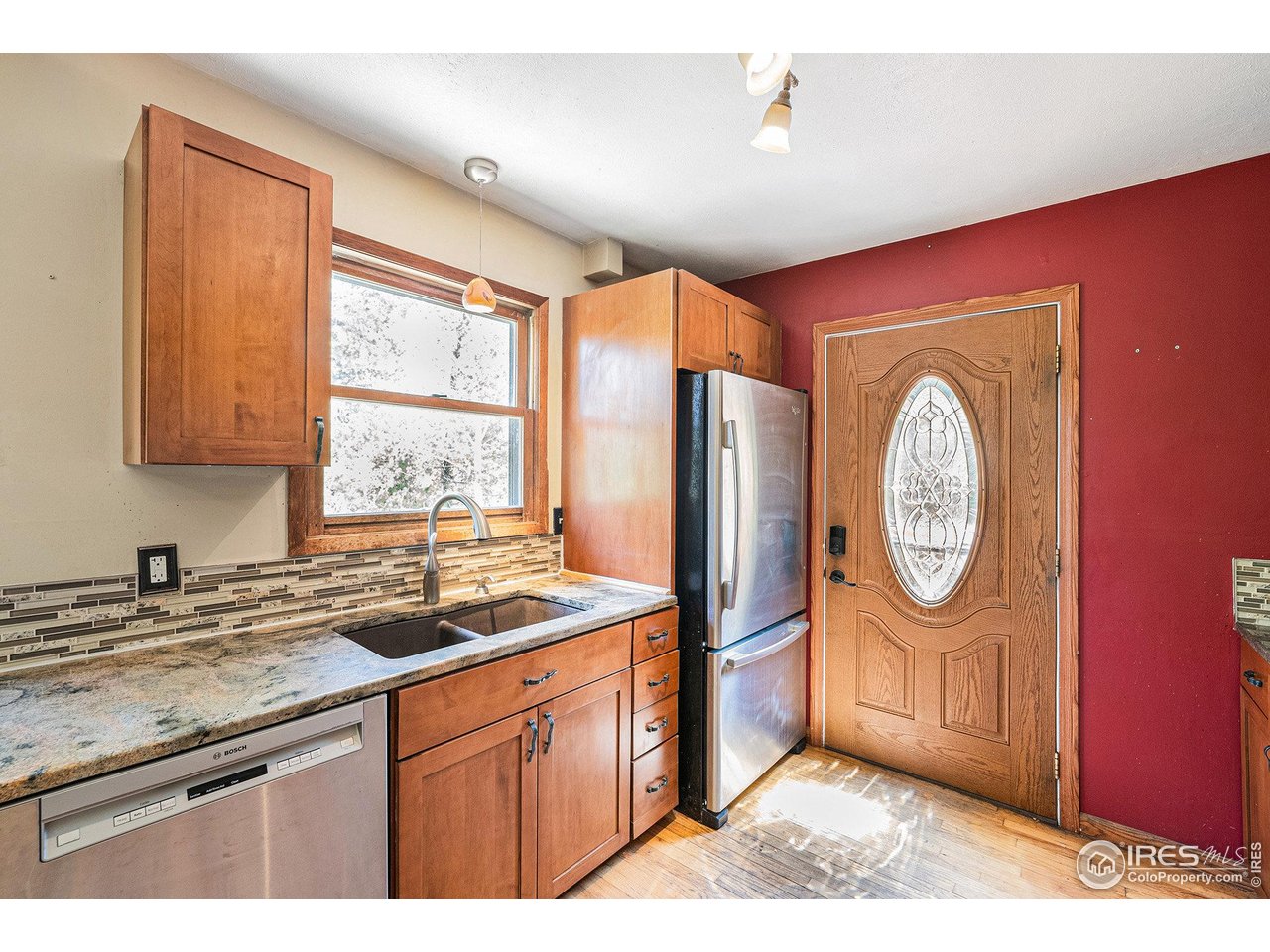 147 St Vrain Trail Ward, CO 80481 - Photo 12 of 31 a kitchen with stainless steel appliances granite countertop a refrigerator a sink a stove and a wooden cabinets