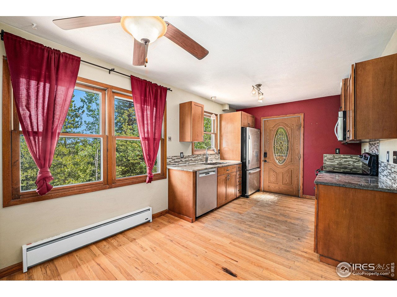147 St Vrain Trail Ward, CO 80481 - Photo 9 of 31 a kitchen with stainless steel appliances granite countertop a stove a sink dishwasher and a refrigerator
