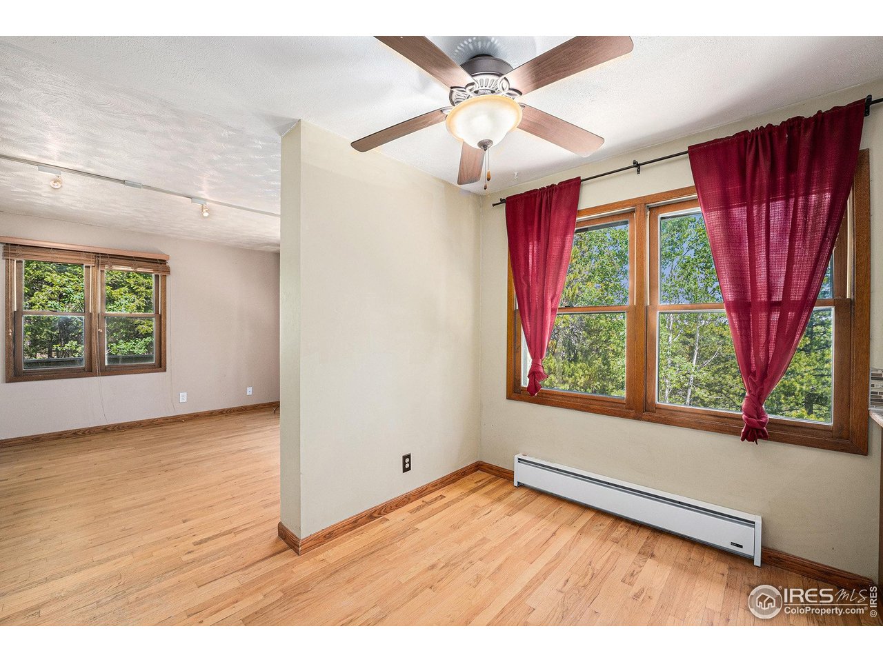 147 St Vrain Trail Ward, CO 80481 - Photo 10 of 31 an empty room with wooden floor and windows