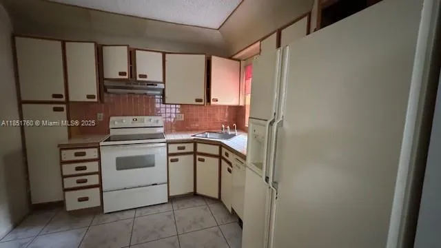 a bathroom with a granite countertop sink a toilet a mirror and bathtub