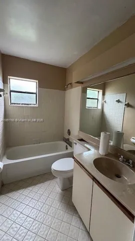 a bathroom with a sink a toilet and bathtub