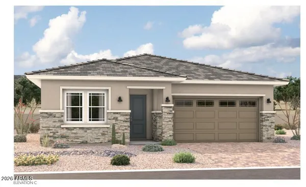 a view of a white house with large windows and a small yard