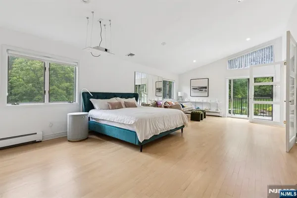 a bedroom with a large bed and a chandelier