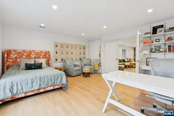 a spacious bedroom with a bed and a couch
