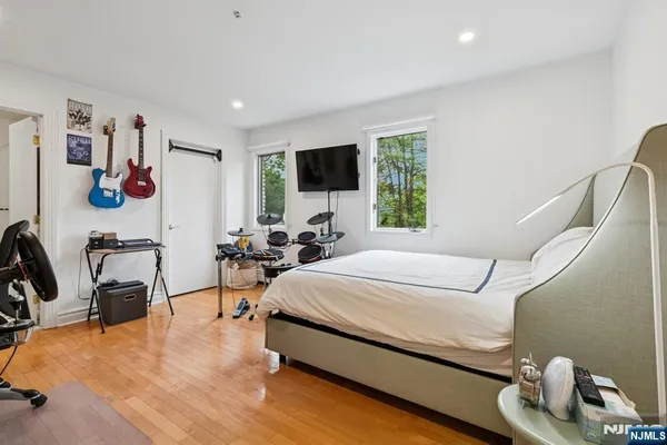 a bed room with a bed and a flat screen tv