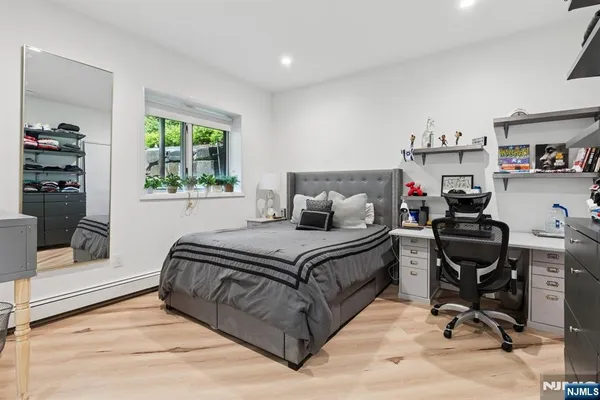 a bedroom with a bed and a large window