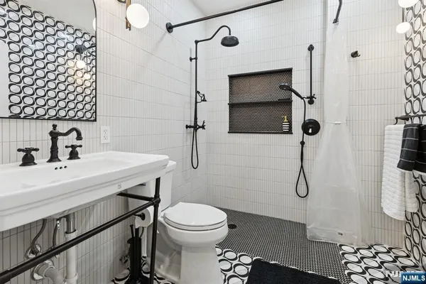 a bathroom with a sink toilet and shower