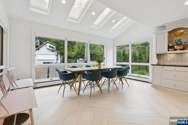 a dining room with furniture and a floor to ceiling window