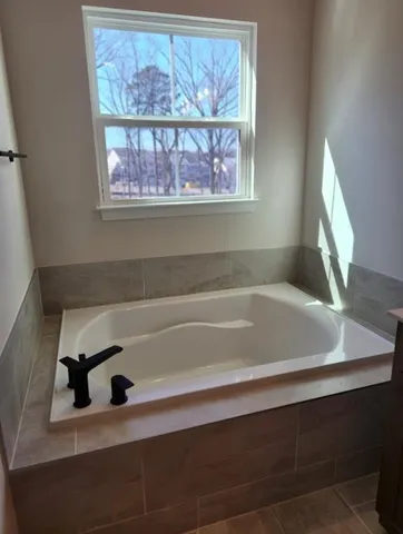 a bathroom with a bathtub and window
