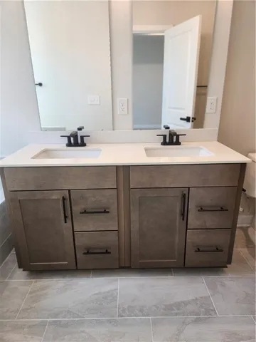 a bathroom with a sink vanity and a mirror