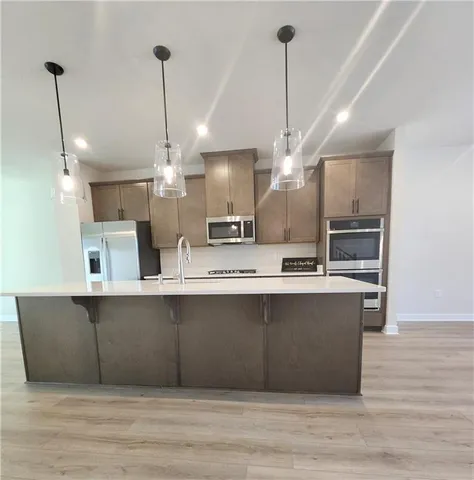 a view of a kitchen with a sink and microwave
