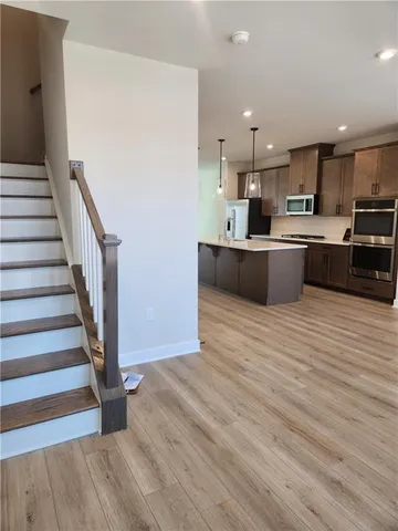 a view of kitchen with sink and wooden floor