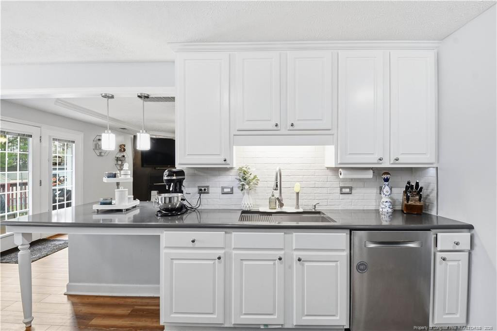 212 Lennox Loop Raeford, NC 28376 - Photo 13 of 47 a kitchen with white cabinets and white appliances