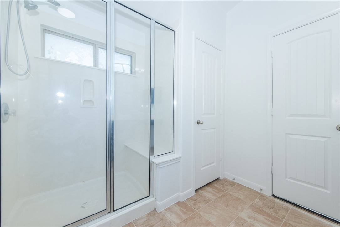 1007 Plateau Trail Georgetown, TX 78626 - Photo 14 of 32 a bathroom with a glass shower door