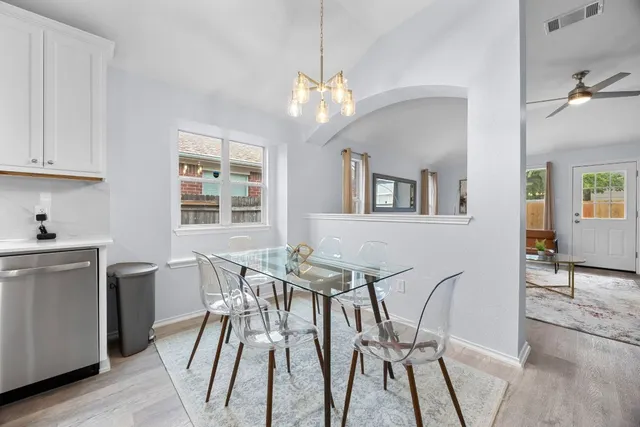 a view of a dining room with furniture and wooden floor