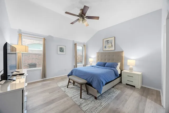 a bedroom with a bed and a flat tv screen on dresser