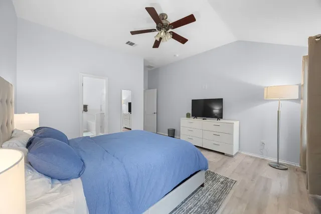 a bedroom with a bed and a flat screen tv