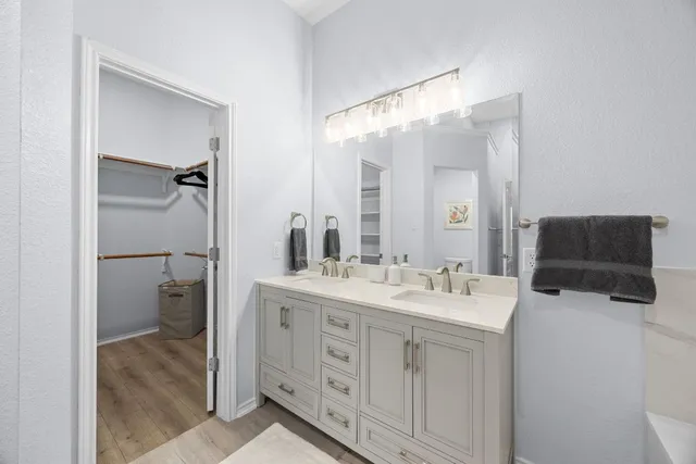 a spacious bathroom with a double vanity sink mirror and toilet