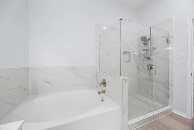 a bathroom with a bathtub and a shower