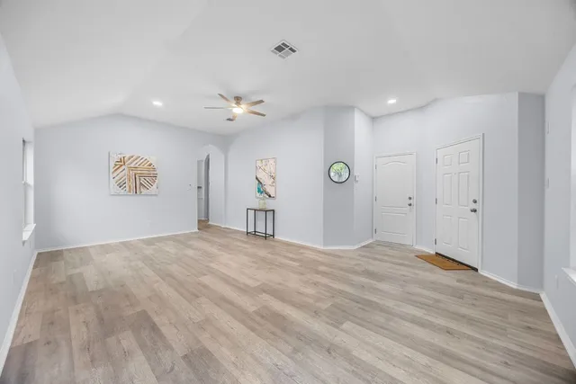 a view of an empty room and a window