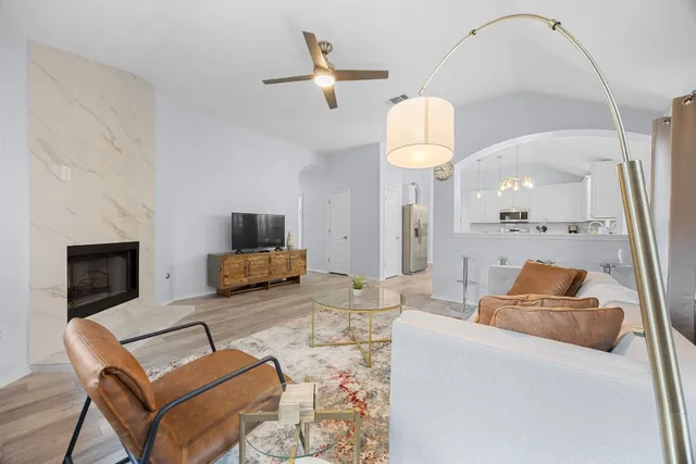 a living room with furniture and a fireplace