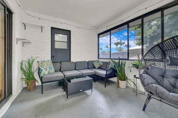 a living room with furniture and a potted plant