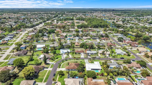 an aerial view of residential houses with outdoor space