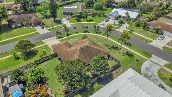 an aerial view of residential house with outdoor space and swimming pool