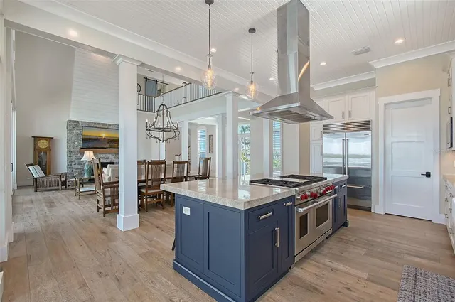 a bedroom with a large bed a large window and a chandelier