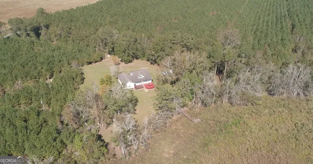 an aerial view of a house with outdoor space