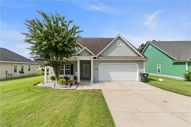 a front view of house with yard and green space