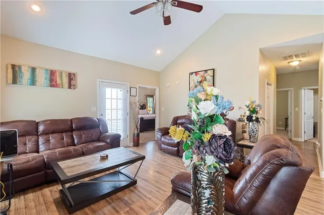 a living room with furniture flowerpot and a chandelier
