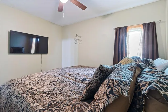 a bedroom with a bed and a flat screen tv