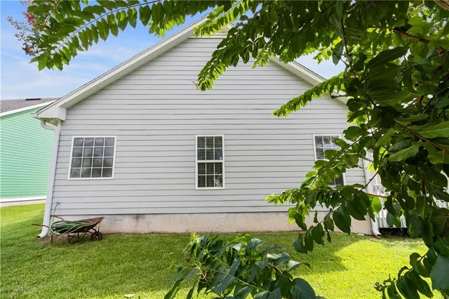 a view of a house with a yard and sitting area