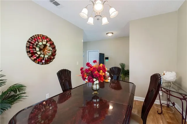 a dining room with furniture and flowers