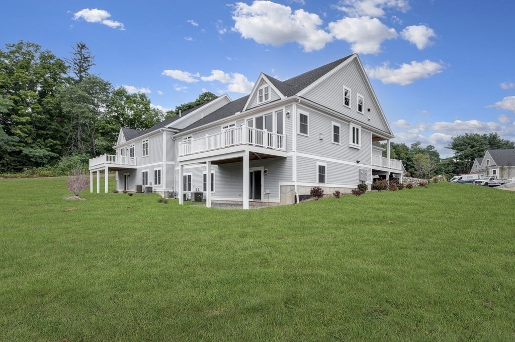 30 Pne Hl Road, Unit 30 Wenham, MA 01984 - Photo 3 of 32 a view of white house with a big yard and large trees