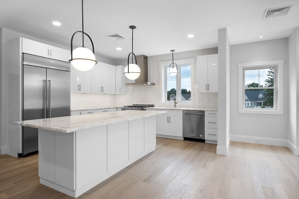 30 Pne Hl Road, Unit 30 Wenham, MA 01984 - Photo 8 of 32 a kitchen with white cabinets and white appliances