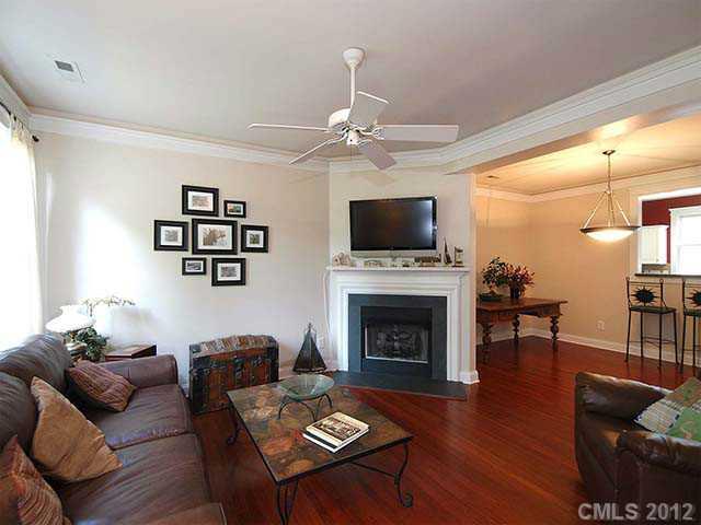 290 Elis Way, Unit 153 Fort Mill, SC 29708 - Photo 3 of 16 a living room with furniture a fireplace and a flat screen tv