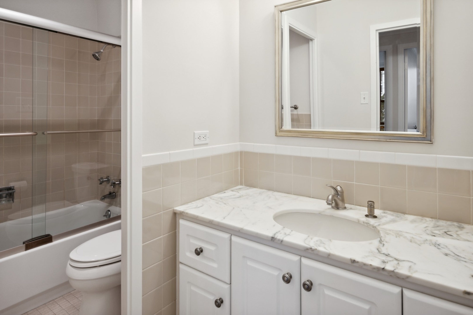 1616 Sheridan Road, Unit 3G Wilmette, IL 60091 - Photo 13 of 20 a bathroom with a granite countertop sink toilet and shower