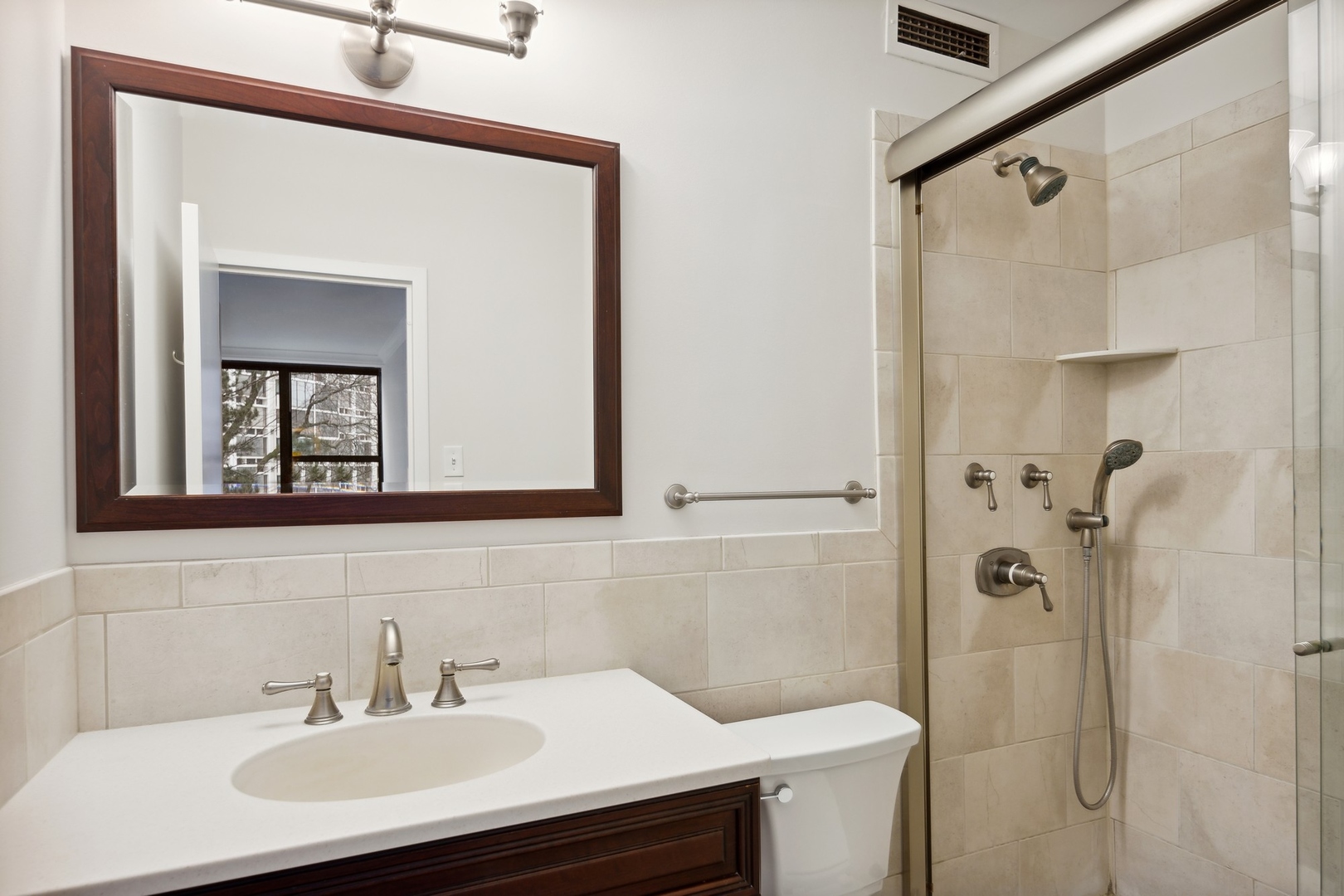 1616 Sheridan Road, Unit 3G Wilmette, IL 60091 - Photo 18 of 20 a bathroom with a sink toilet and shower