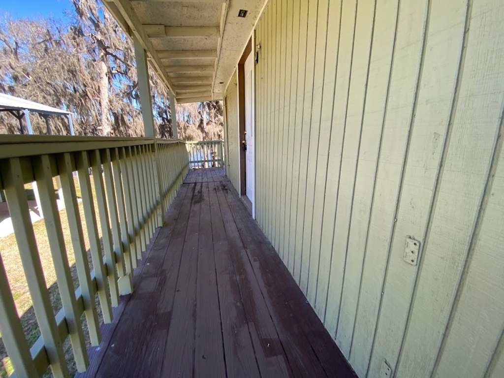 201 Ferguson Drive Cleveland, TX 77327 - Photo 9 of 38 a view of balcony with wooden floor