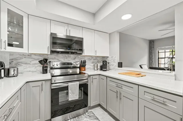 a kitchen with a sink stove and microwave