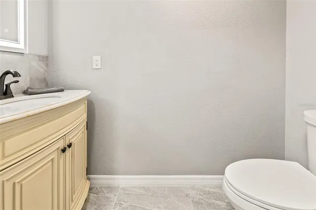 a bathroom with a sink a toilet and vanity