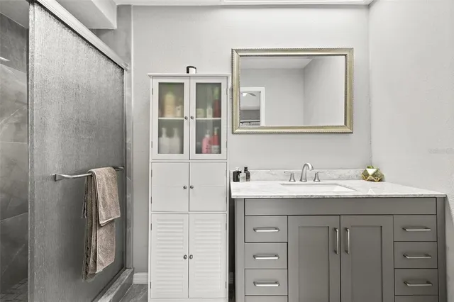 a bathroom with a sink vanity and a mirror
