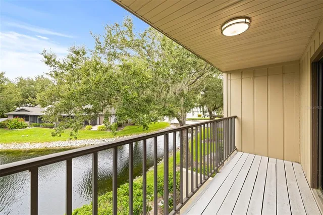 a view of a balcony with wooden floor