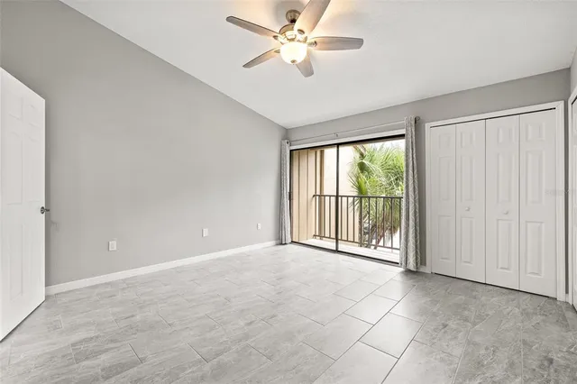 a view of a livingroom with a ceiling fan and window