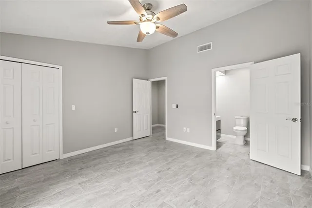 an empty room with fan and a ceiling fan