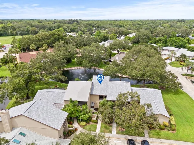 an aerial view of a house with a yard and lake view